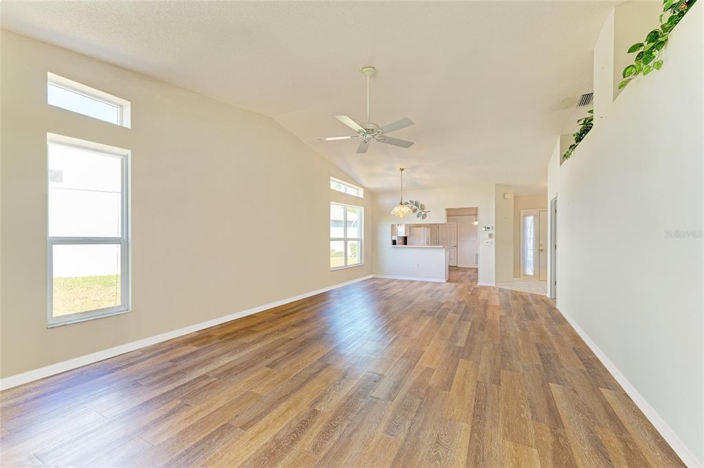 919 Spring Lakes Boulevard Bradenton, FL 34210 - Photo 14 of 43 an empty room with wooden floor and windows