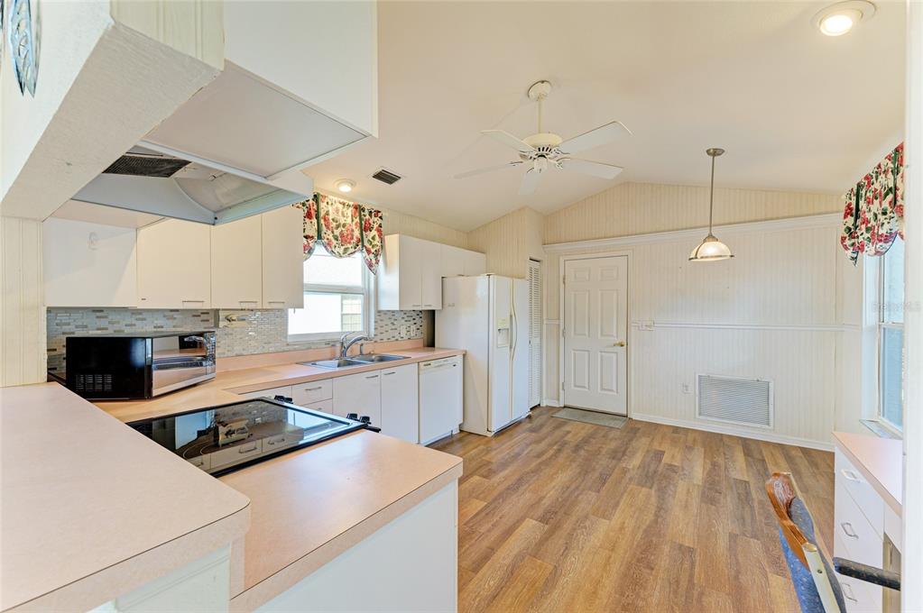 919 Spring Lakes Boulevard Bradenton, FL 34210 - Photo 16 of 43 a kitchen with a stove a sink and a refrigerator