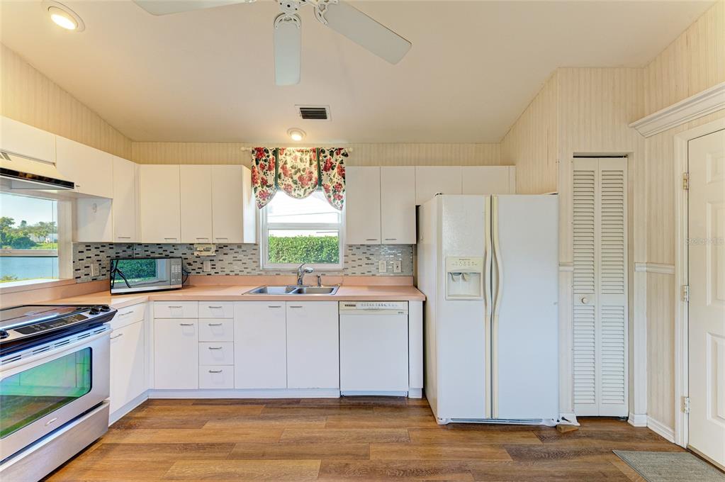 919 Spring Lakes Boulevard Bradenton, FL 34210 - Photo 17 of 43 a kitchen with a sink window and cabinets