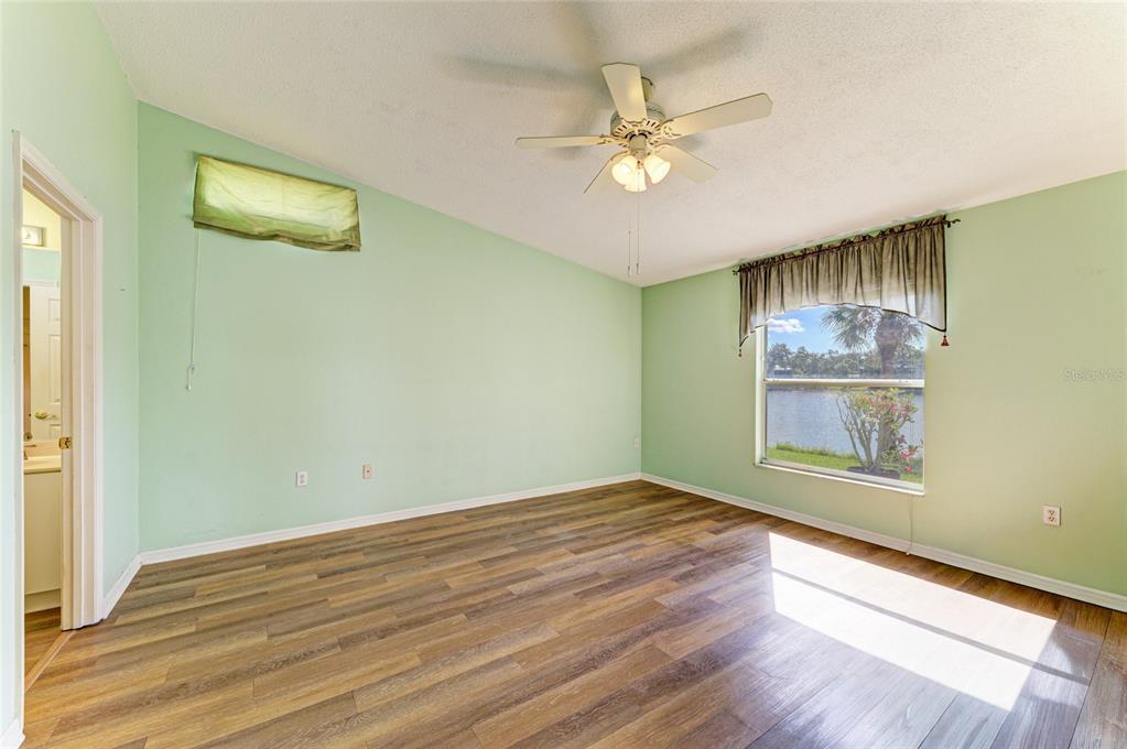 919 Spring Lakes Boulevard Bradenton, FL 34210 - Photo 19 of 43 a view of an empty room with wooden floor and a window