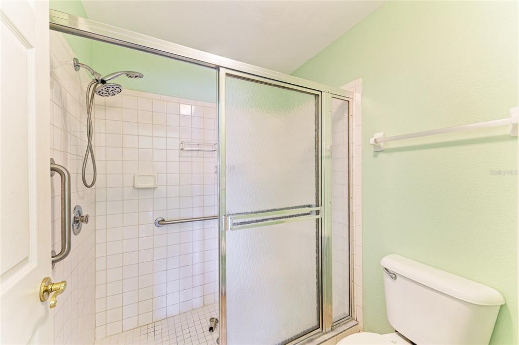 919 Spring Lakes Boulevard Bradenton, FL 34210 - Photo 25 of 43 a bathroom with a shower and a toilet