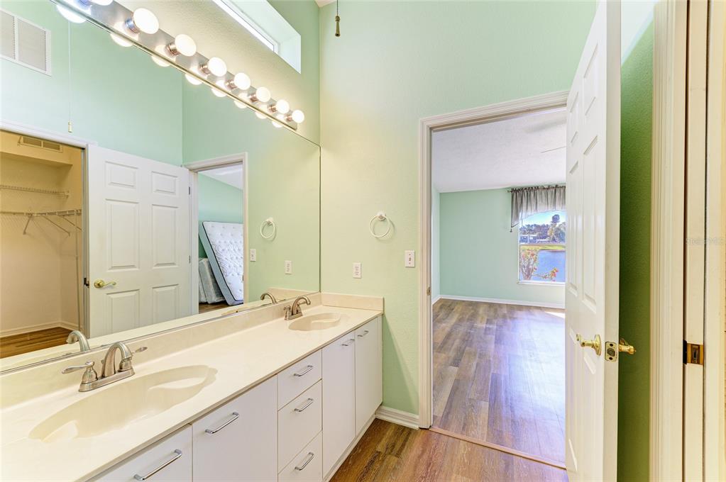 919 Spring Lakes Boulevard Bradenton, FL 34210 - Photo 26 of 43 a bathroom with a double vanity sink and a mirror