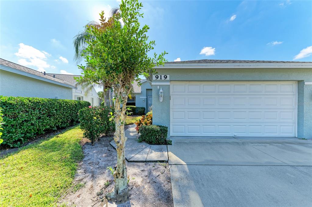 919 Spring Lakes Boulevard Bradenton, FL 34210 - Photo 3 of 43 a front view of a house with a yard and garage