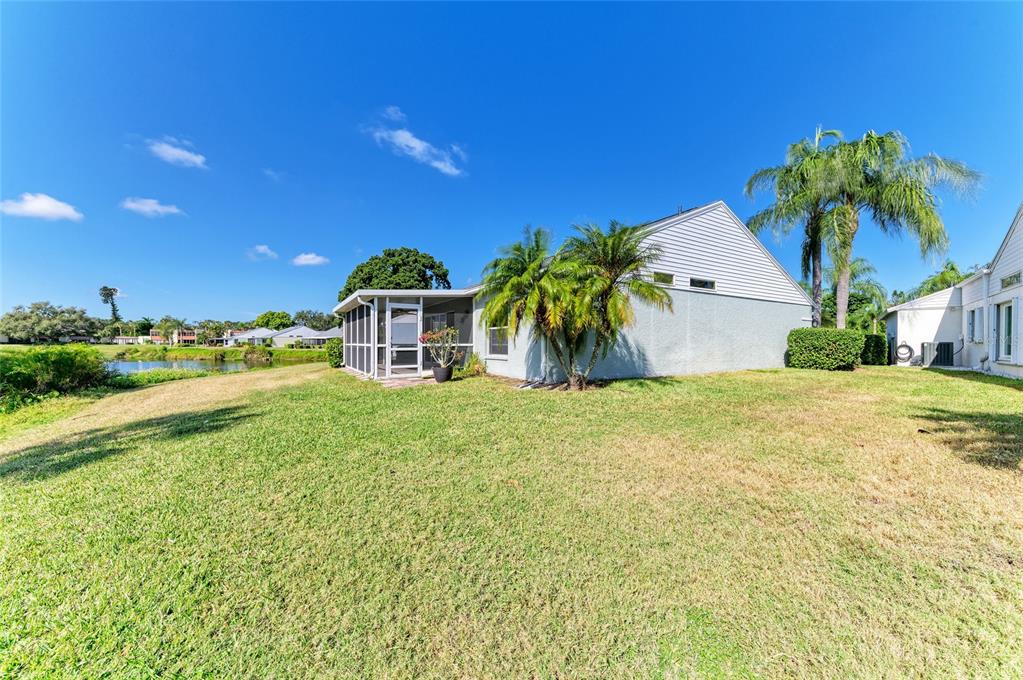 919 Spring Lakes Boulevard Bradenton, FL 34210 - Photo 37 of 43 a view of a house with a yard and palm trees