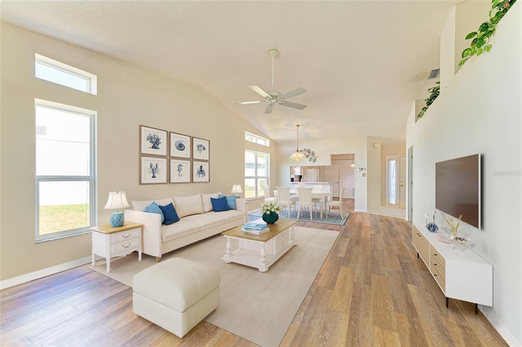 919 Spring Lakes Boulevard Bradenton, FL 34210 - Photo 8 of 43 a living room with furniture wooden floor and a flat screen tv