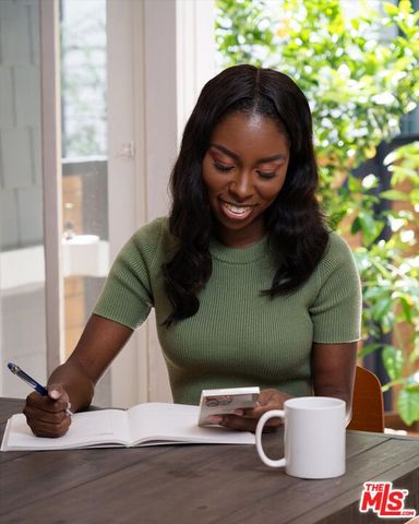 a kitchen with granite countertop a table chairs stove and cabinets