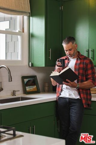 a kitchen with stainless steel appliances white cabinets and a refrigerator