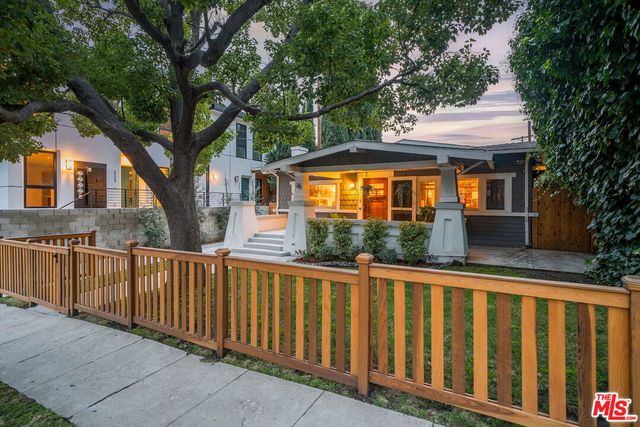 a view of a brick house with large windows