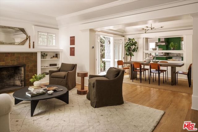 a living room with furniture wooden floor and a fireplace