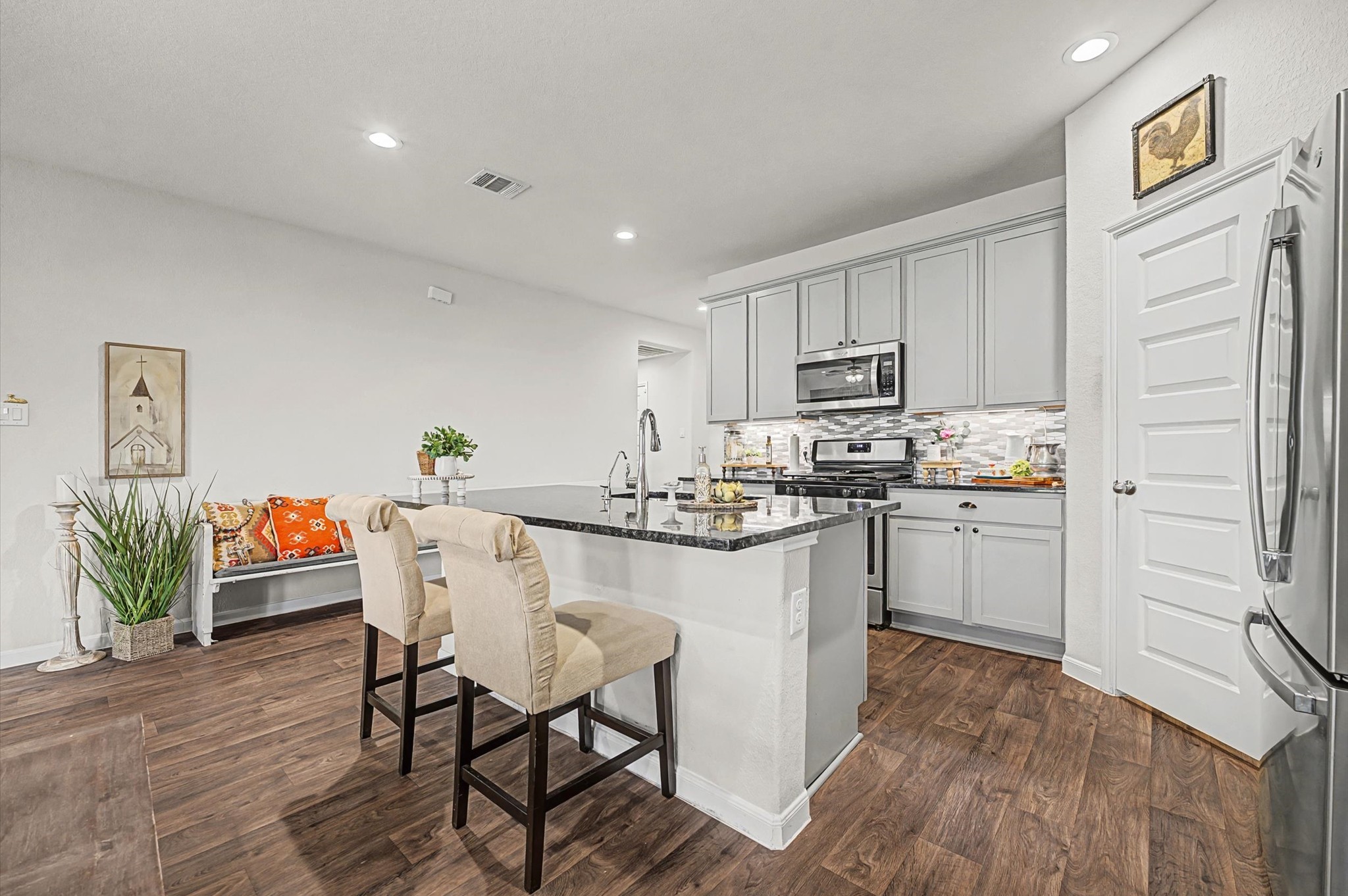 222 Kickapoo Drive Anahuac, TX 77514 - Photo 2 of 17 a kitchen with white cabinets and stainless steel appliances