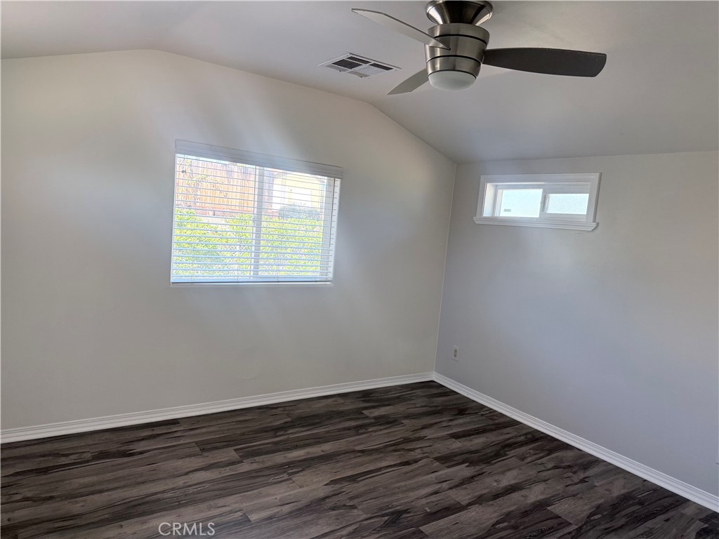 22480 Grand, Unit A Wildomar, CA 92595 - Photo 6 of 7 a view of an empty room with wooden floor and a window