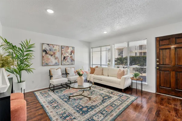 a living room with furniture rug and wooden floor