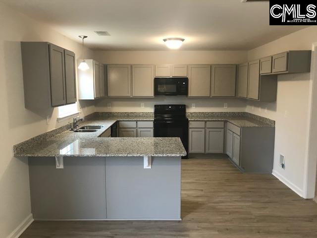 1069 Acacia Lane Columbia, SC 29229 - Photo 5 of 11 a large kitchen with stainless steel appliances granite countertop a sink a stove top oven a counter space and cabinets