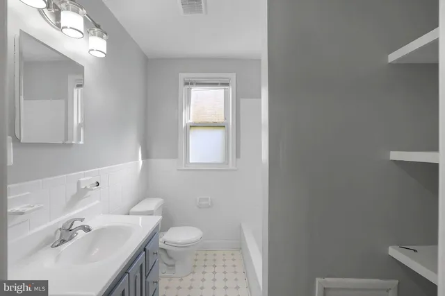 a bathroom with a sink toilet and tub
