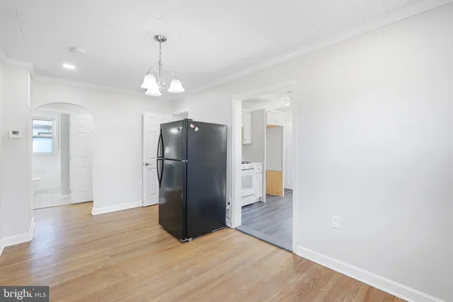 a view of a kitchen with a refrigerator and a stove top oven