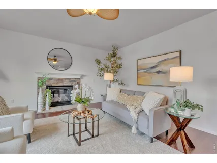 a living room with furniture a fireplace and a table