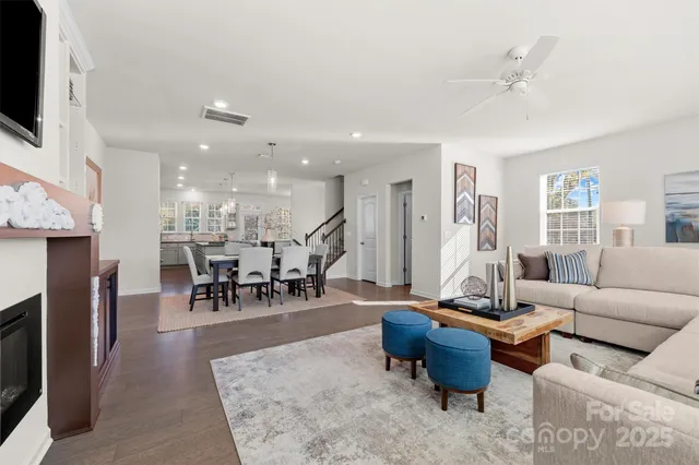 a living room with furniture a fireplace and a flat screen tv