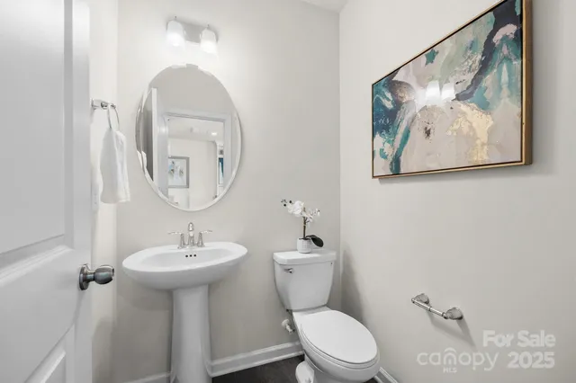 a bathroom with a toilet a sink and mirror