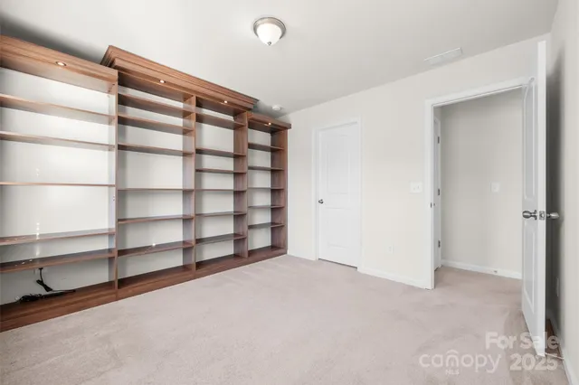 a view of an empty room with empty shelves