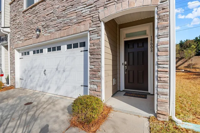 a view of front door and small yard