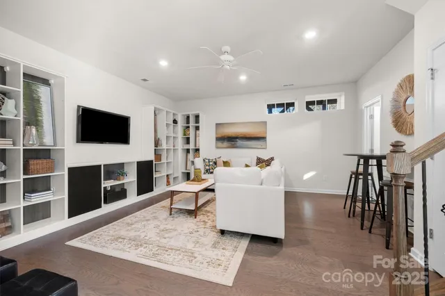 a living room with furniture flat screen tv and a fireplace