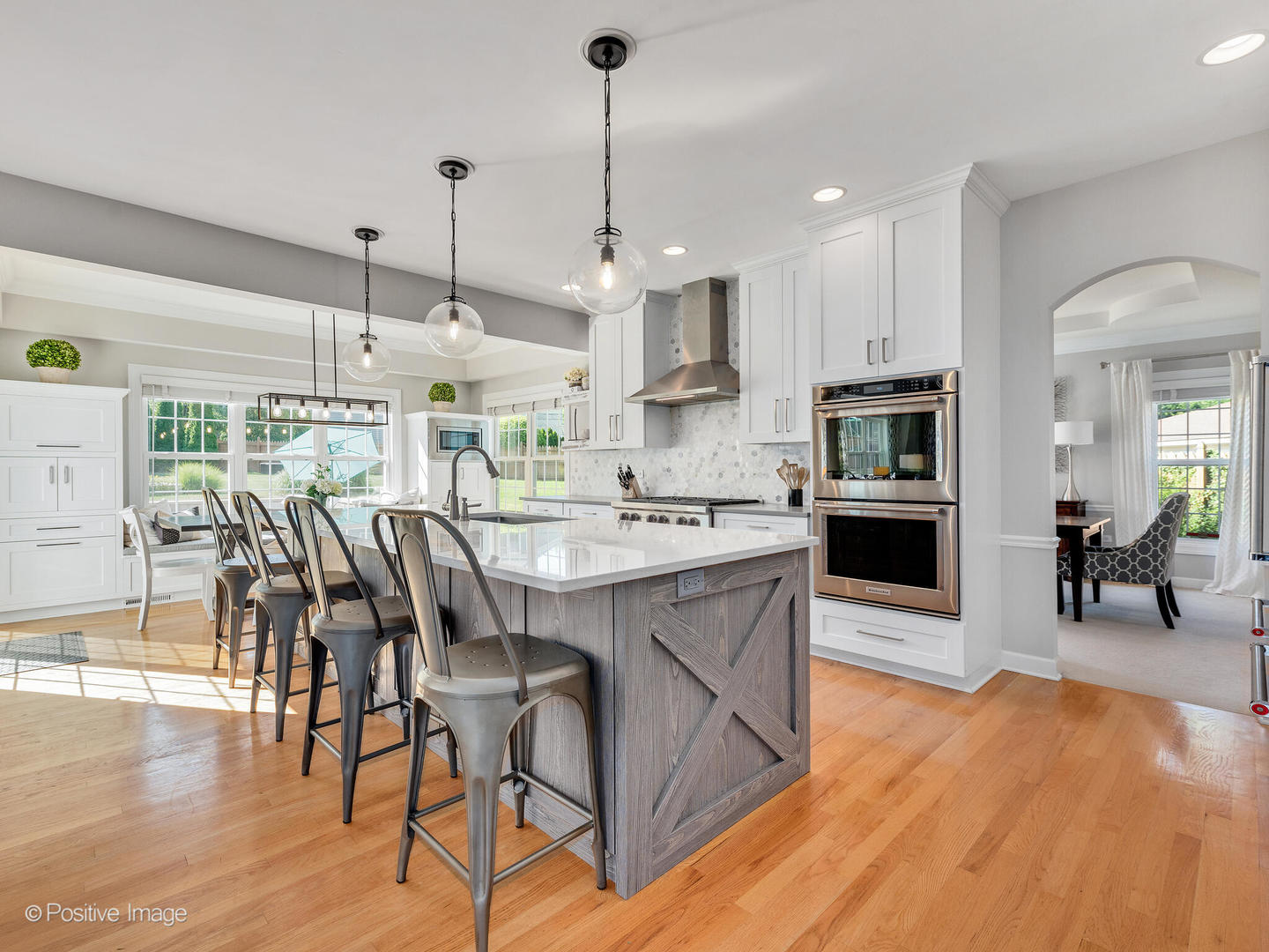 822 Ranch Road Wheaton, IL 60187 - Photo 7 of 36 a kitchen with stainless steel appliances granite countertop a stove top oven a sink dishwasher a dining table and chairs with wooden floor