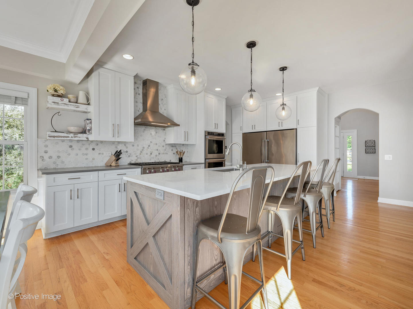 822 Ranch Road Wheaton, IL 60187 - Photo 8 of 36 a kitchen with stainless steel appliances granite countertop a stove top oven a sink a dining table and chairs with wooden floor