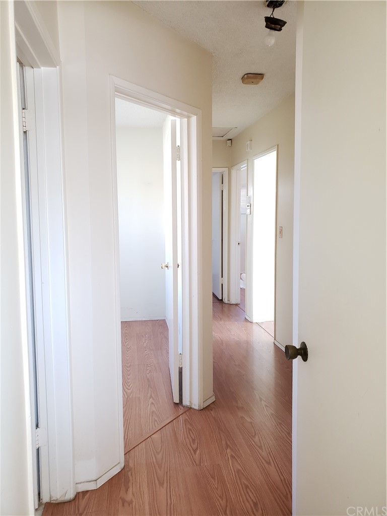 11929 Ranchito Street El Monte, CA 91732 - Photo 6 of 28 a view of a hallway with wooden floor