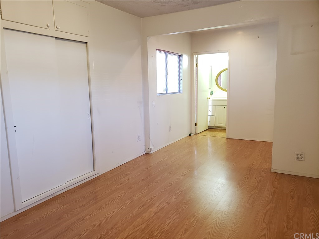 11929 Ranchito Street El Monte, CA 91732 - Photo 9 of 28 an empty room with wooden floor and windows