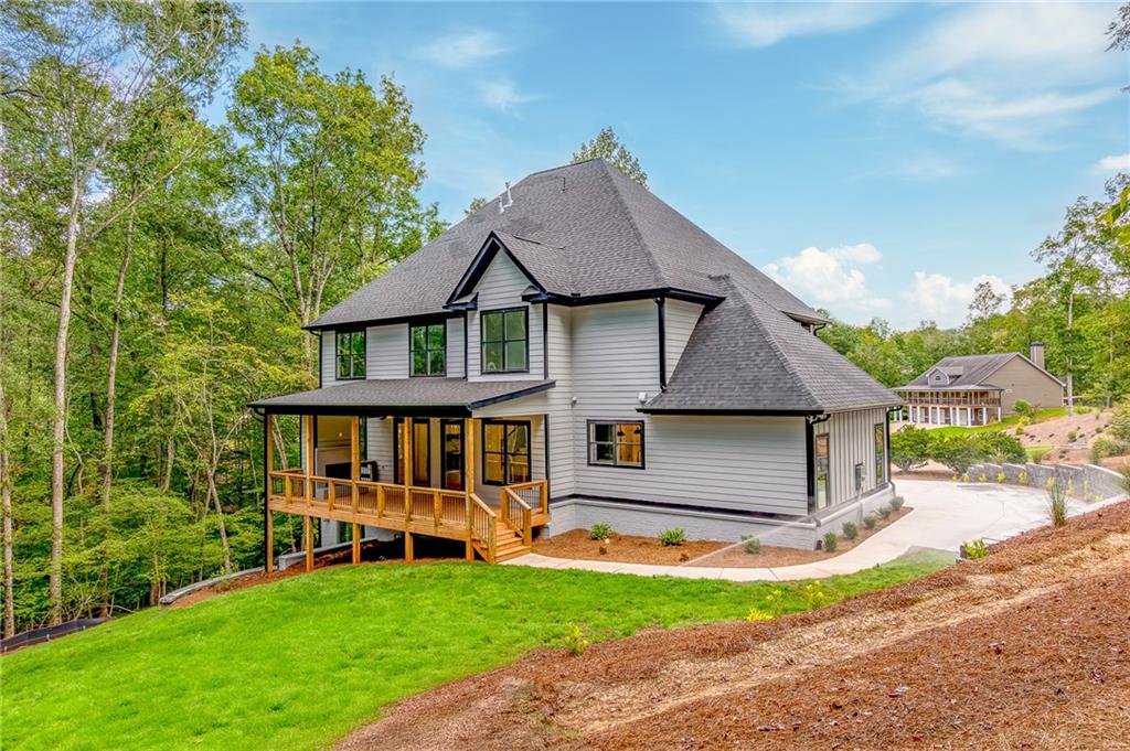 6008 Tradewinds Cove Gainesville, GA 30506 - Photo 11 of 73 a front view of a house with garden