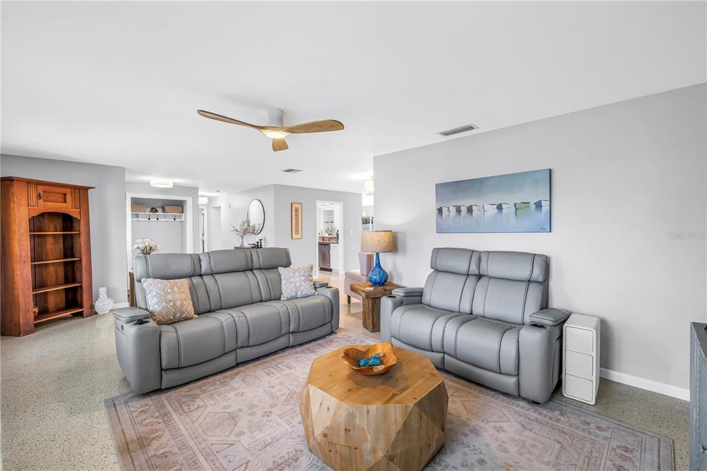 14546 Anchorage Circle Seminole, FL 33776 - Photo 12 of 88 a living room with furniture a ceiling fan and a rug
