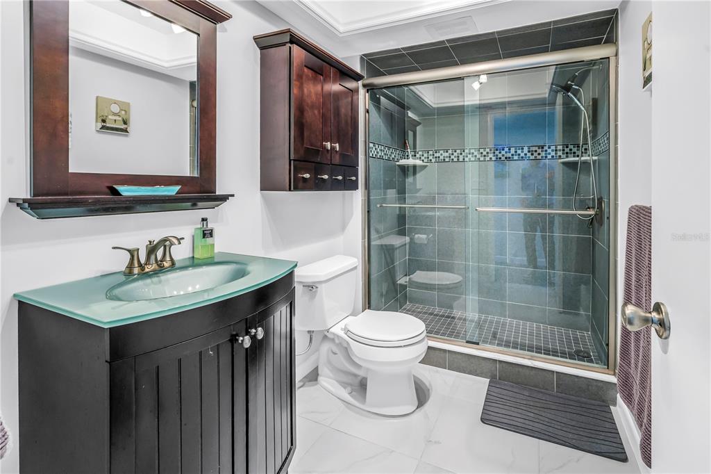 14546 Anchorage Circle Seminole, FL 33776 - Photo 16 of 88 a bathroom with a sink toilet a mirror and shower