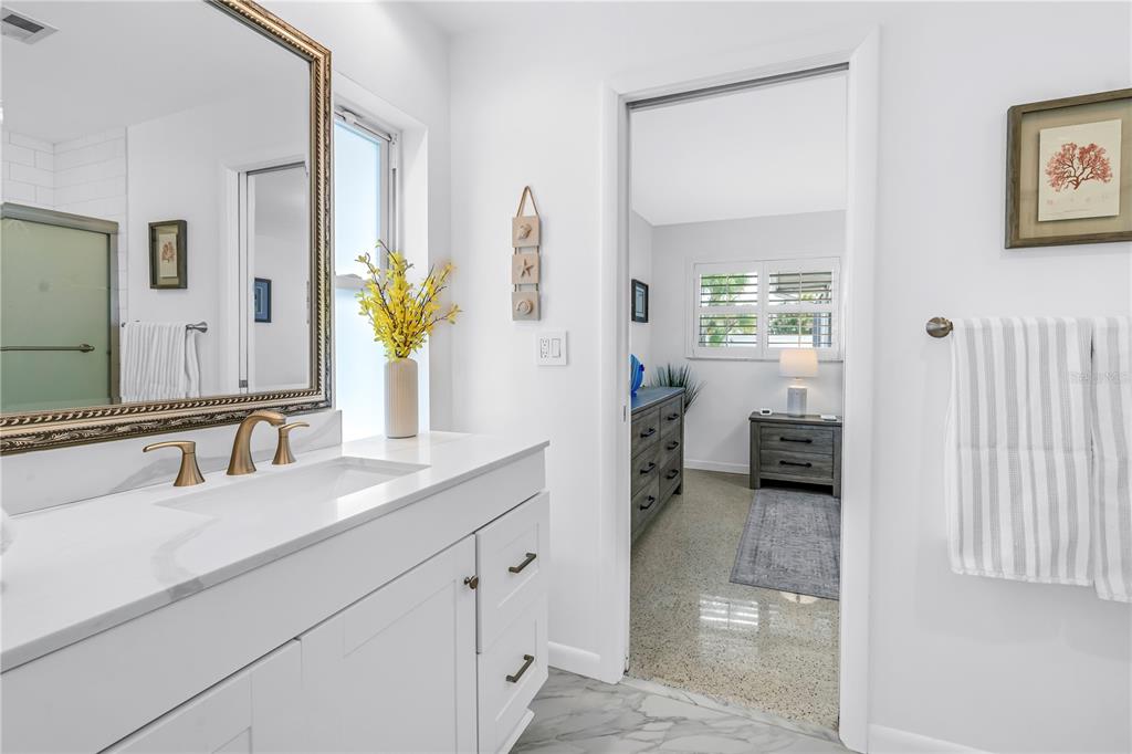 14546 Anchorage Circle Seminole, FL 33776 - Photo 19 of 88 a en suite bathroom with a double vanity sink and a mirror