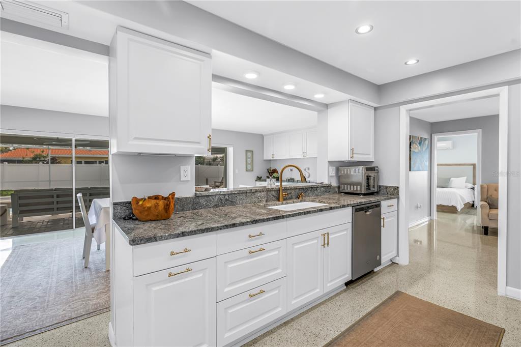14546 Anchorage Circle Seminole, FL 33776 - Photo 32 of 88 a kitchen with stainless steel appliances granite countertop a sink and cabinets