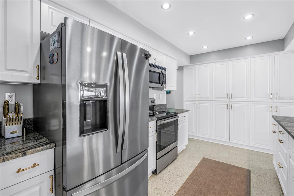 14546 Anchorage Circle Seminole, FL 33776 - Photo 33 of 88 a kitchen with stainless steel appliances granite countertop a refrigerator a stove and a sink