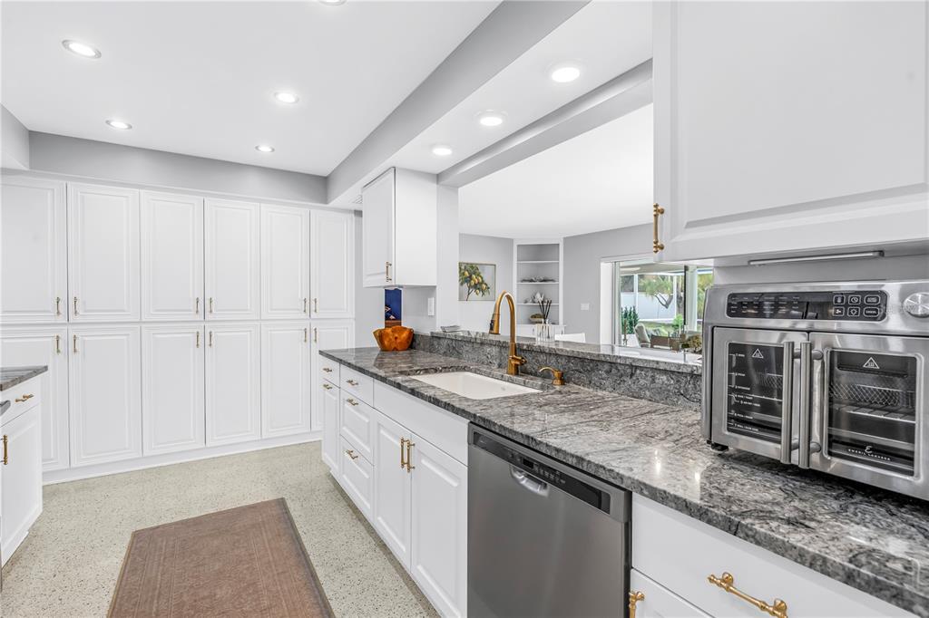 14546 Anchorage Circle Seminole, FL 33776 - Photo 34 of 88 a kitchen with stainless steel appliances granite countertop a sink and a stove