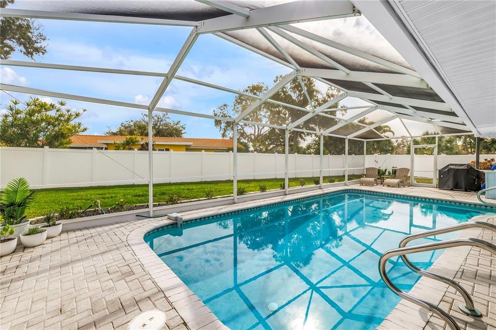 14546 Anchorage Circle Seminole, FL 33776 - Photo 47 of 88 a view of a backyard with swimming pool and sitting area