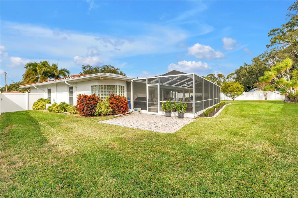 14546 Anchorage Circle Seminole, FL 33776 - Photo 58 of 88 a view of a house with a big yard and potted plants