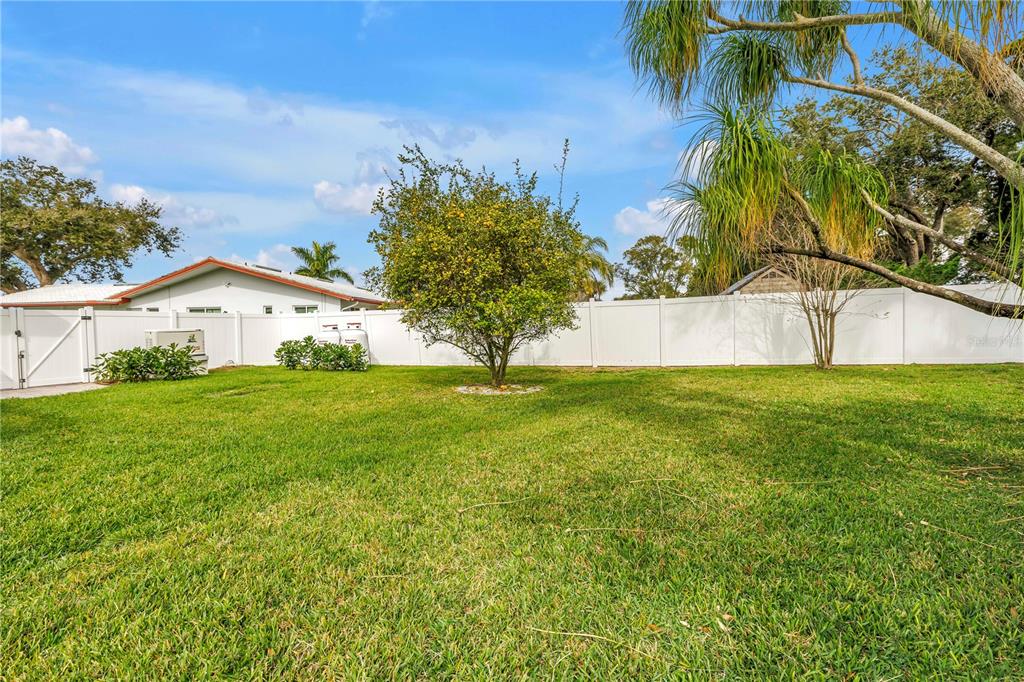 14546 Anchorage Circle Seminole, FL 33776 - Photo 60 of 88 a view of yard with swimming pool and green space