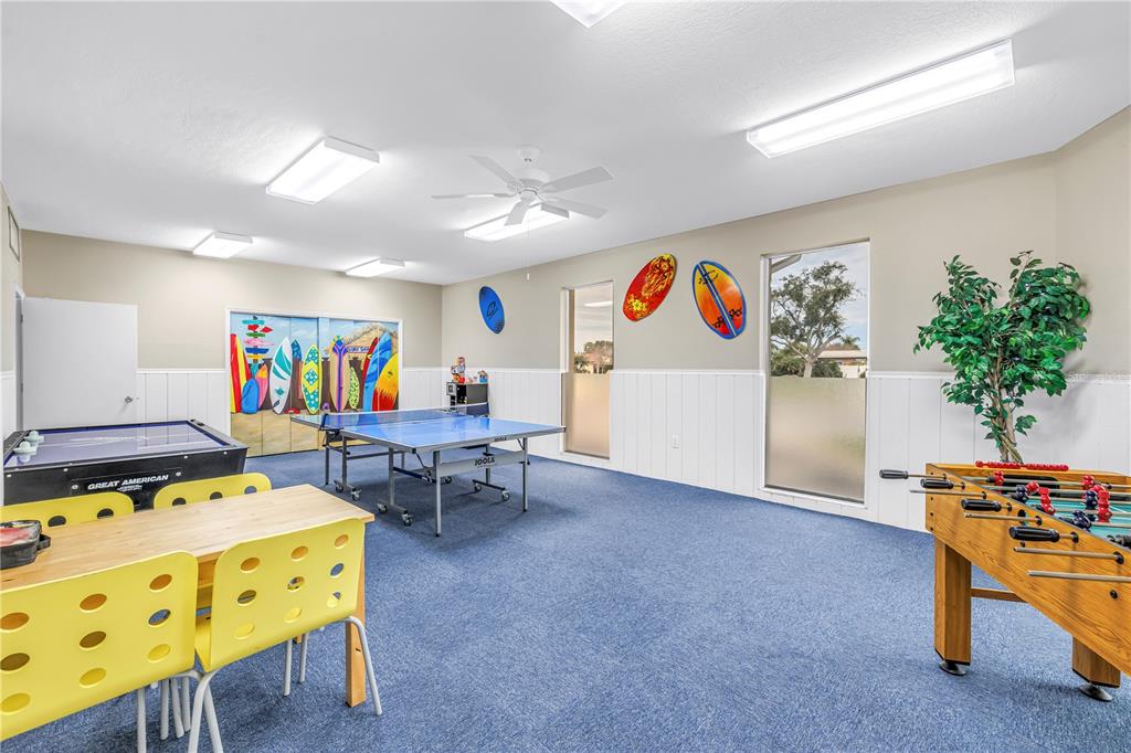 14546 Anchorage Circle Seminole, FL 33776 - Photo 65 of 88 a living room with furniture and a dining table with potted plants on the table