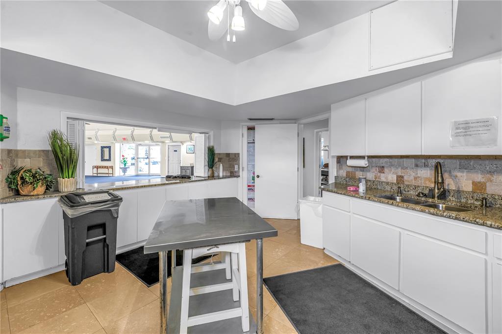 14546 Anchorage Circle Seminole, FL 33776 - Photo 73 of 88 a kitchen with granite countertop a stove a sink and a refrigerator