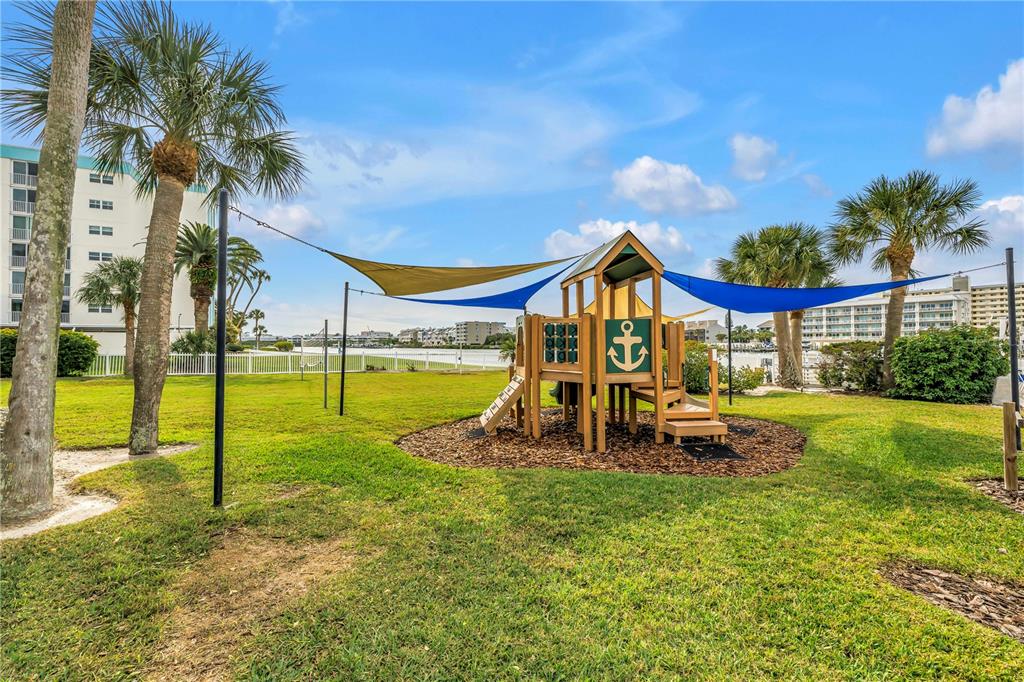 14546 Anchorage Circle Seminole, FL 33776 - Photo 78 of 88 a view of a house with swimming pool and a yard