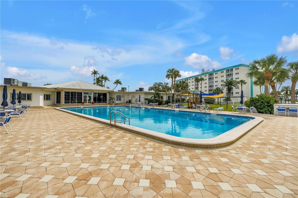 14546 Anchorage Circle Seminole, FL 33776 - Photo 81 of 88 a view of a house with swimming pool and a yard