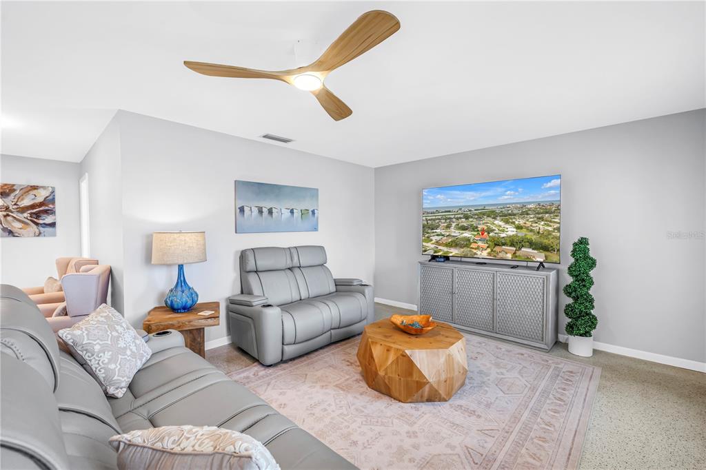 14546 Anchorage Circle Seminole, FL 33776 - Photo 10 of 88 a living room with furniture and a flat screen tv