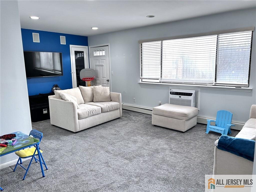 532 Cricket Lane, Unit 532 Woodbridge, NJ 07095 - Photo 11 of 14 a living room with furniture and a flat screen tv