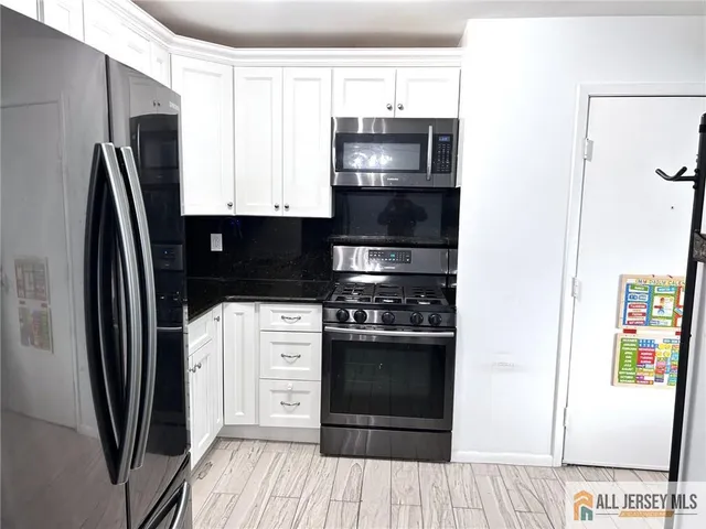 a kitchen with stainless steel appliances a refrigerator stove and sink