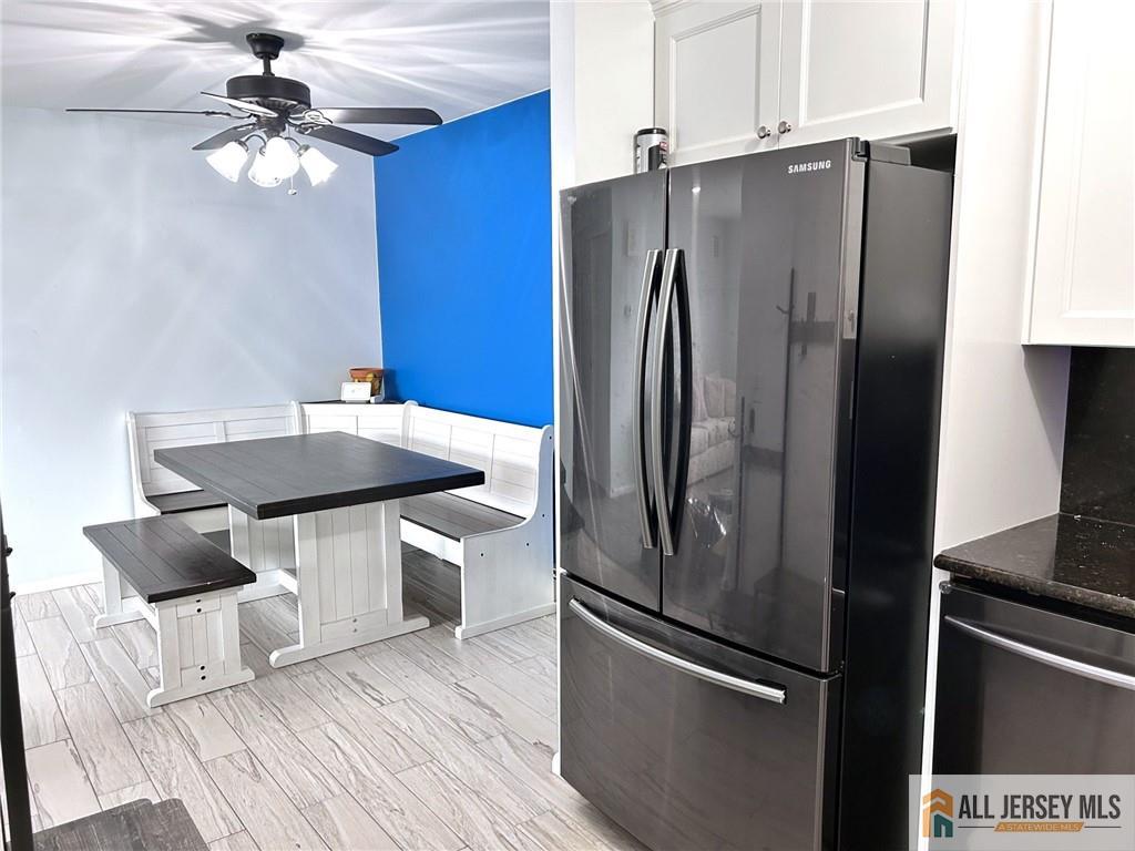 532 Cricket Lane, Unit 532 Woodbridge, NJ 07095 - Photo 3 of 14 a kitchen with stainless steel appliances wooden floor and a refrigerator