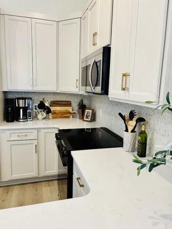 a kitchen with a sink a stove and cabinets