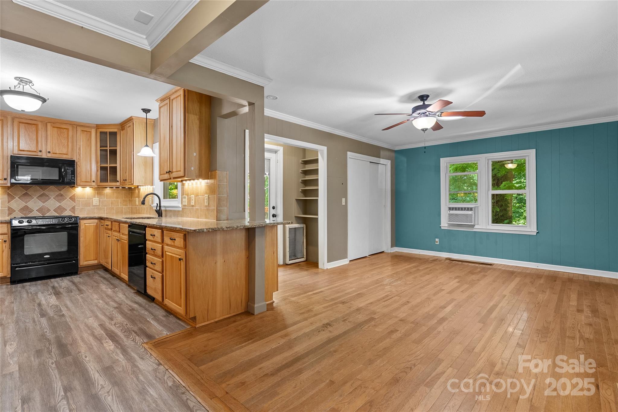 80 Laurel Avenue Tryon, NC 28782 - Photo 14 of 43 a open kitchen with stainless steel appliances granite countertop a stove top oven a sink dishwasher a dining table and chairs with wooden floor