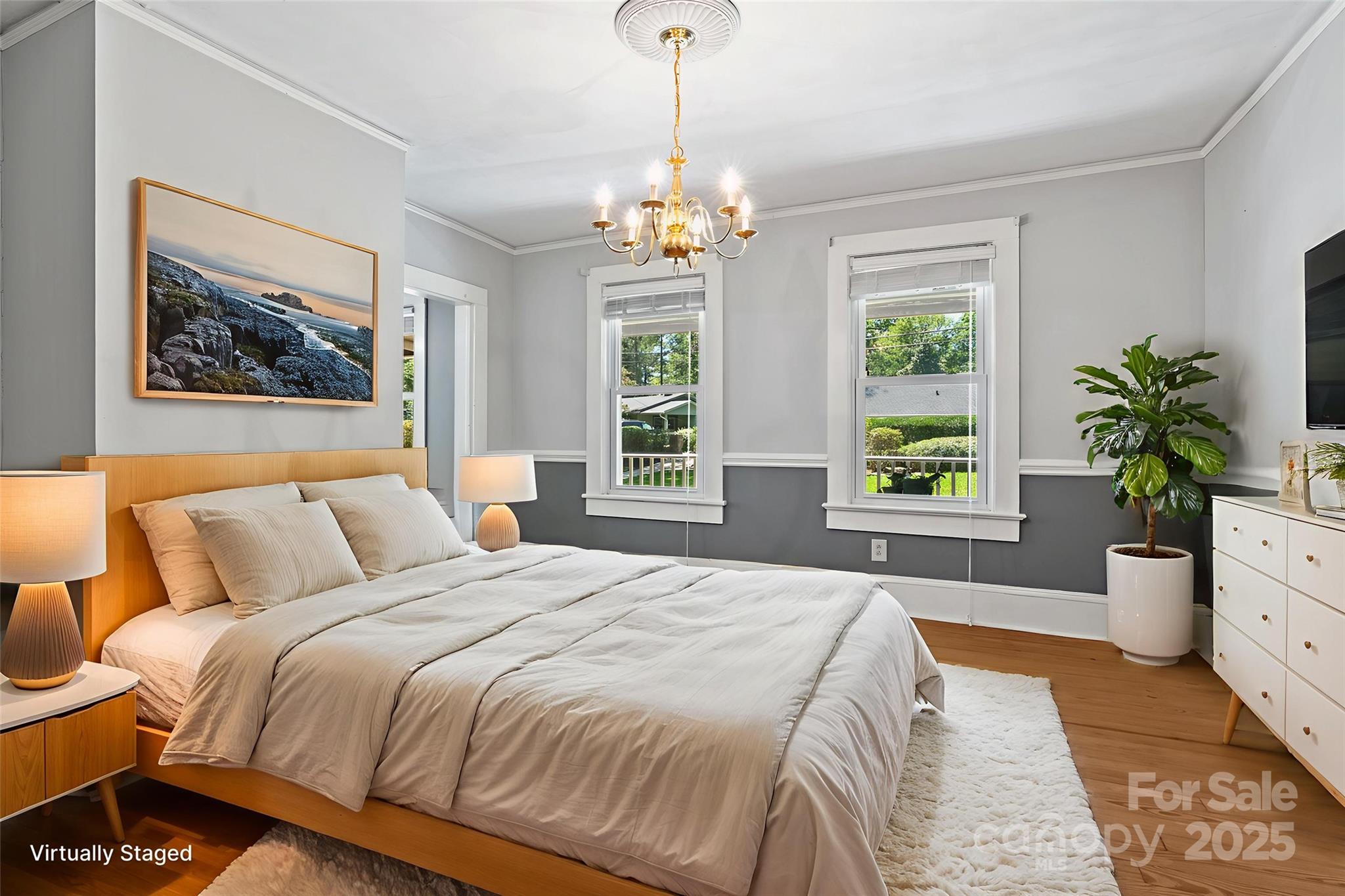 80 Laurel Avenue Tryon, NC 28782 - Photo 19 of 43 a bedroom with a large bed and a chandelier